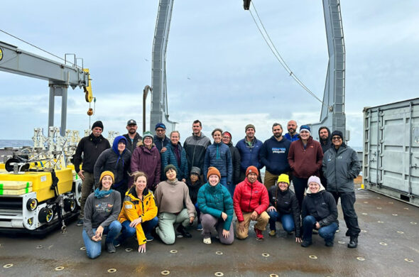 Photo of a group of people on the back of a research vessel.