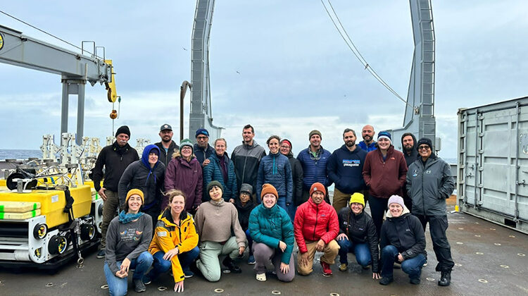 Photo of a group of people on the back of a research vessel.