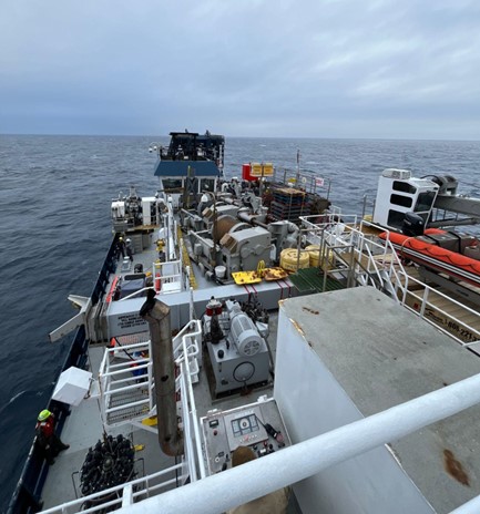 Looking over the equipment and instruments on the deck of a ship in the middle of the ocean