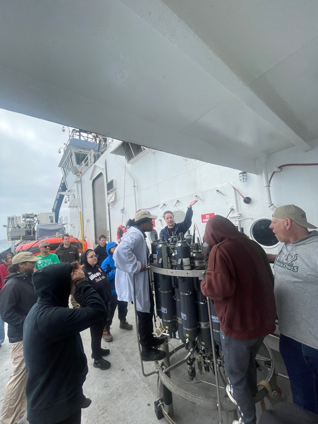 A group of scientists looking at a CTD rosette