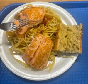 Plate of spaghetti, garlic bread, and salmon