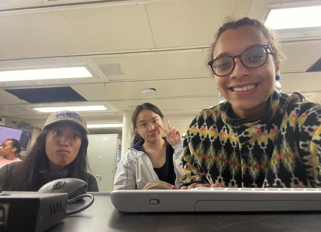 Three scientists smile for the camera