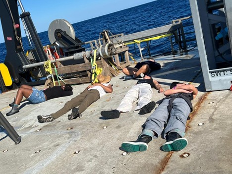 students nap on the boat deck