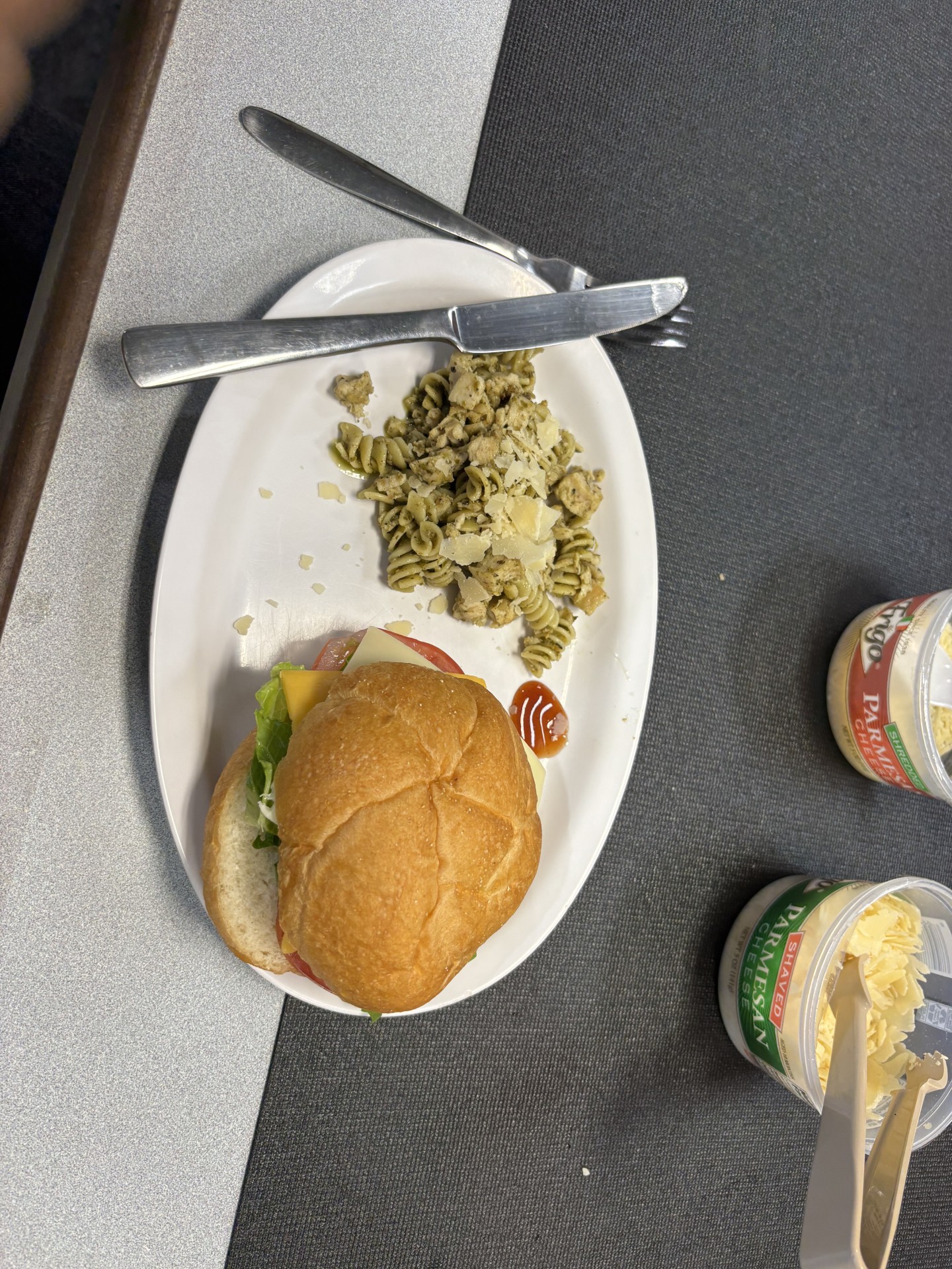 a meal of a chicken sandwich and pasta salad