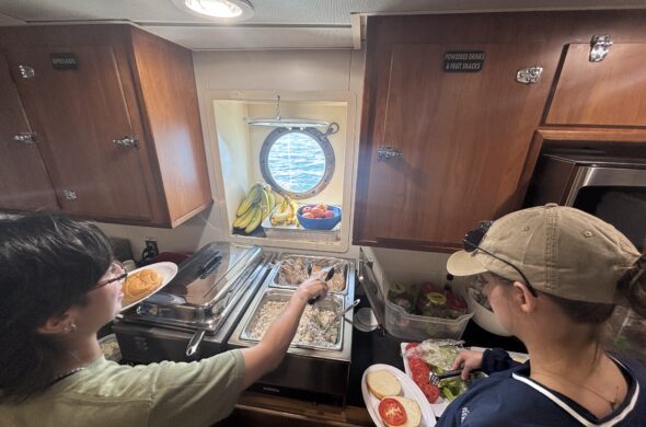 students getting food at the kitchen buffet