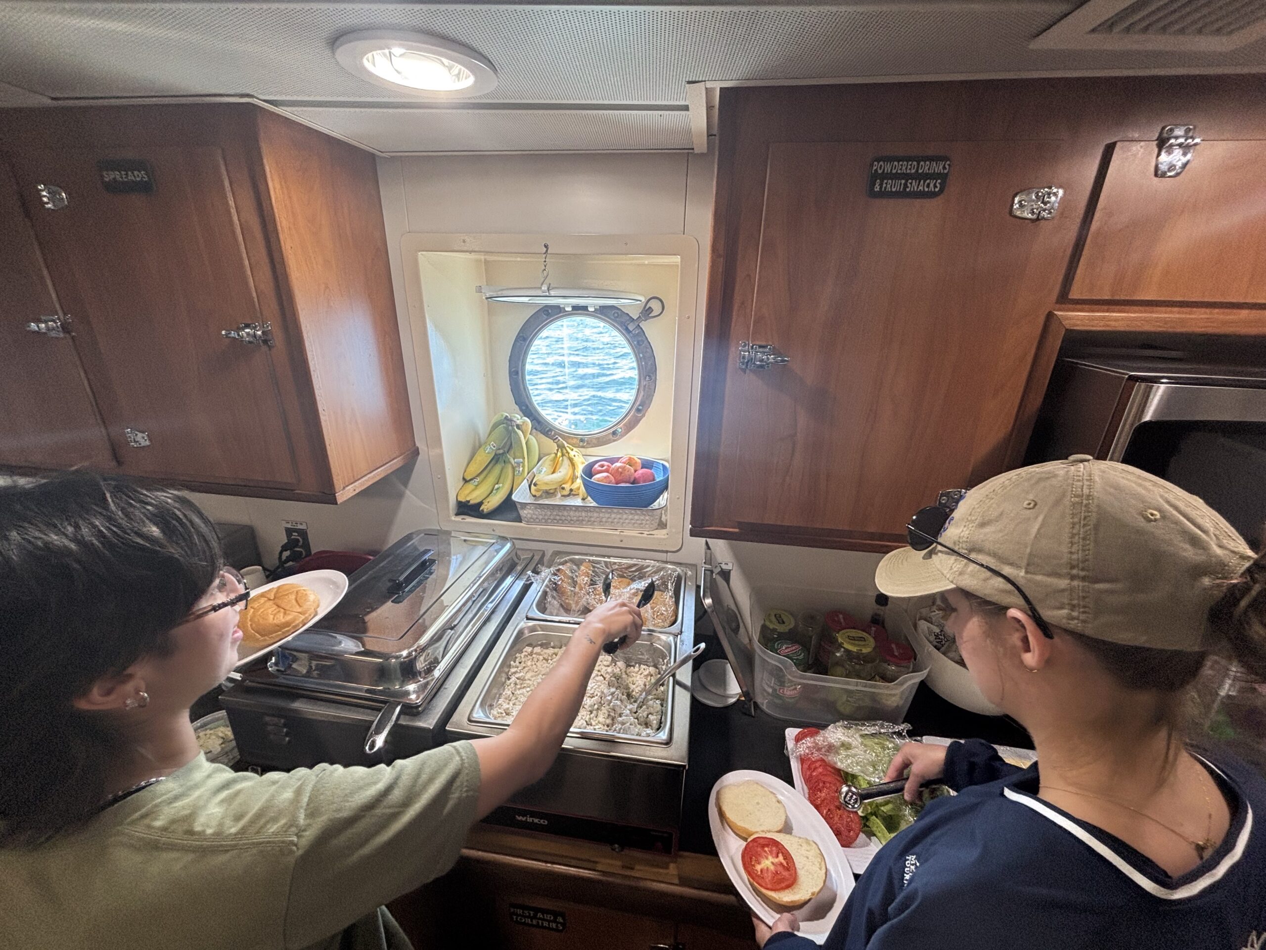 students getting food at the kitchen buffet