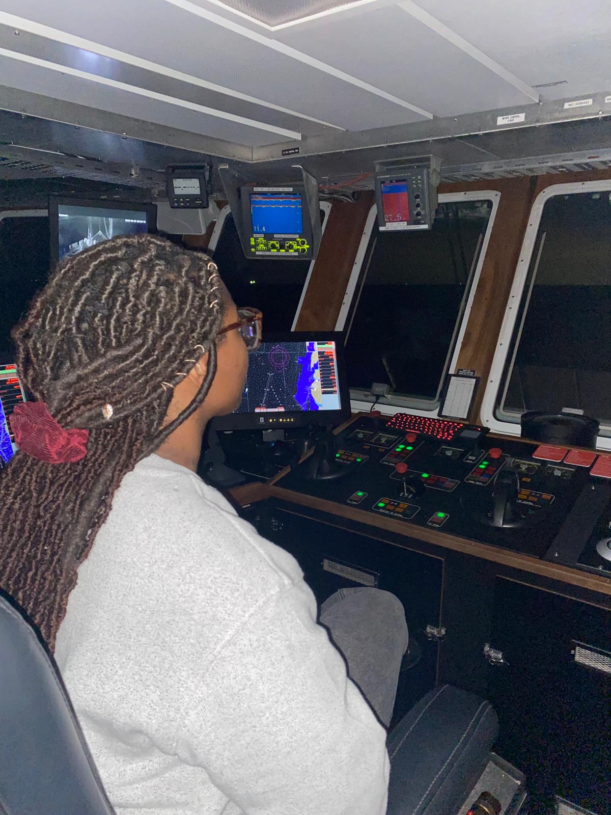 girl sitting on captain's chair