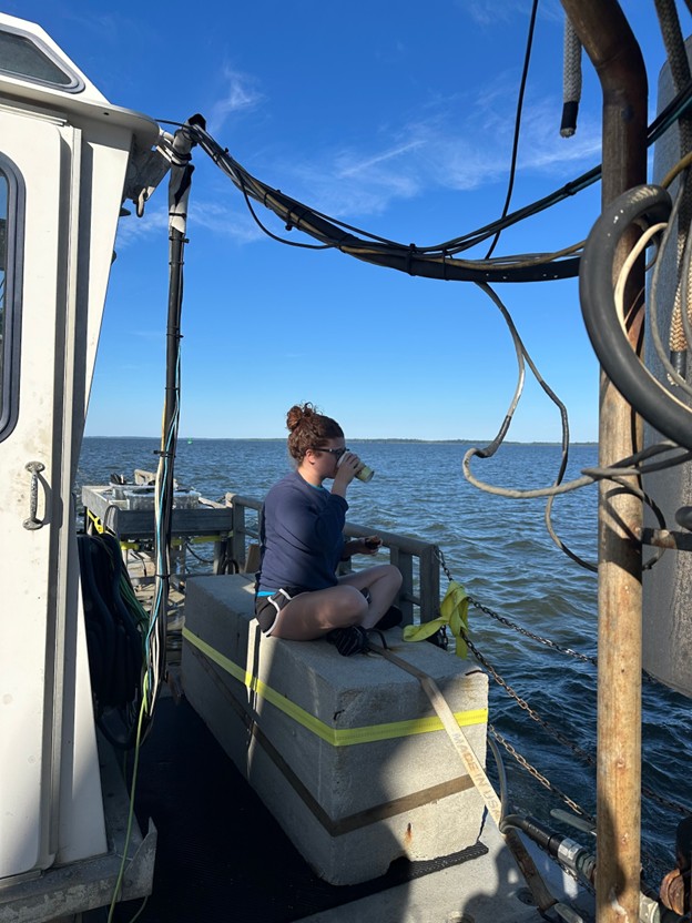 scientist sitting on a cinderblock on the back deck