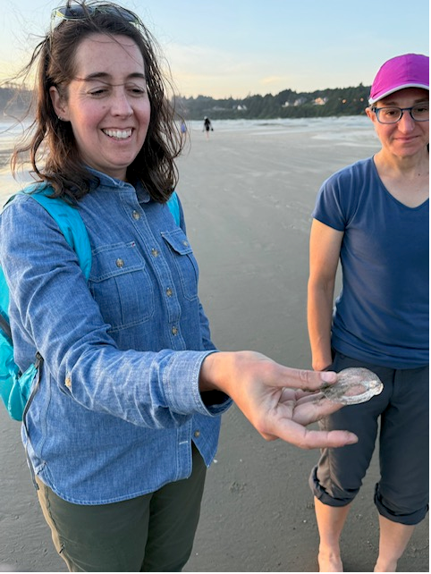 Dana holding a water jellyfish as Beth looks at it