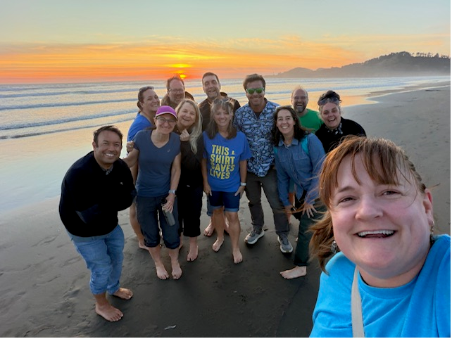 group photo on the beach at sunset