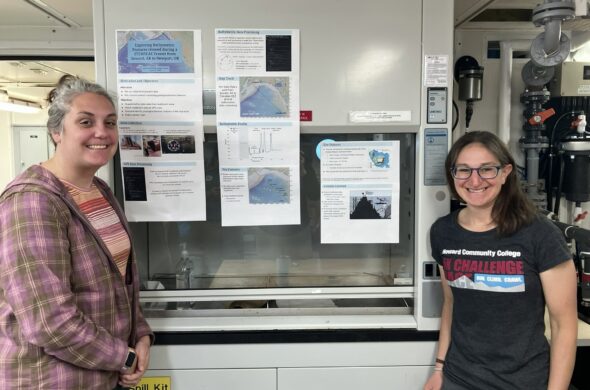 Jordan and Beth posing by their presentation poster
